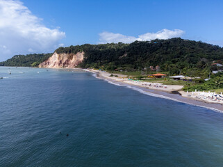 Beautiful orange cliffs with medicinal properties closed with beach in Gamboa, Bahia, Brazil