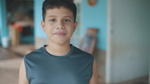 Latin boy walking to the camera smiling