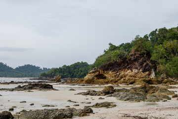 Fototapeta na wymiar Outdoor cloudy view on the beach at Hin Talu Beach in Koh Phayam island in Thailand. 