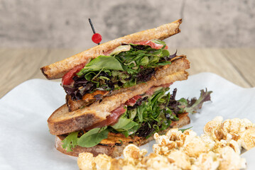 Huge BLT bacon, lettuce, tomato sandwich loaded ingredients into a double deck meal