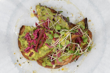 Overhead view of super avocado toast topped with watercress will start any day with a nutrional boost