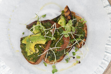 Overhead view of super Pesto toast topped with watercress will start any day with a nutrional boost