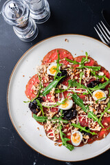 Marbled beef carpaccio with arugula and parmesan cheese