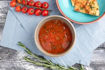 Tomato soup, tomato soup on a white wooden background, top view