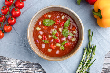 Tomato soup, tomato soup on a white wooden background, top view