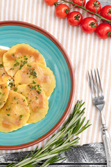 ravioli, italian ravioli on a white wooden background, top view