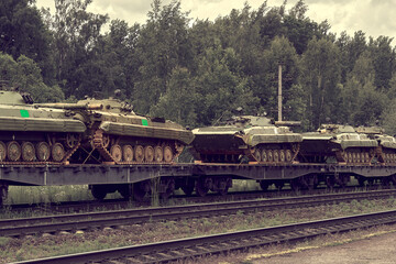 Old Russian military equipment is transferred by rail. Infantry fighting vehicles on railway wagons.