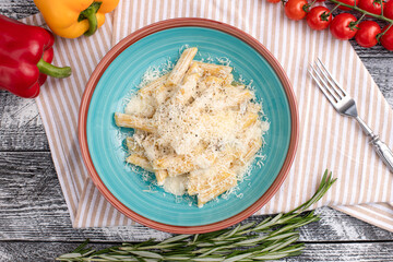 Pasta with cheese, pasta on a white wooden background, top view