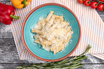 Pasta with cheese, pasta on a white wooden background, top view