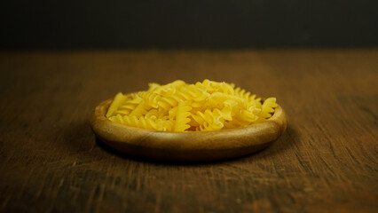 pasta in a dish dry appetizing spiral macaroni in the kitchen food preparation