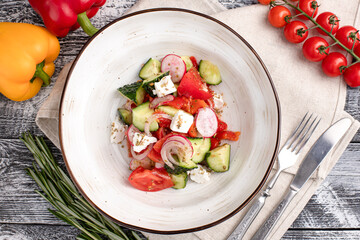 salad, salad of fresh vegetables on a white wooden background, top view