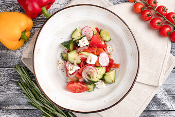 salad, salad of fresh vegetables on a white wooden background, top view