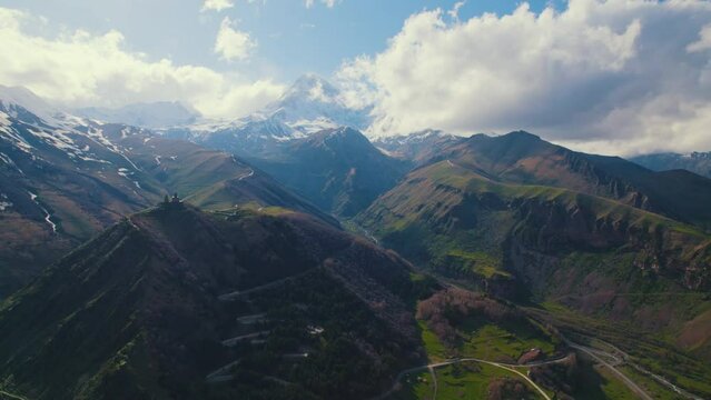 Natural mountain surroundings of Stepantsminda hamlet and raw dangerous mountain roads. High quality 4k footage