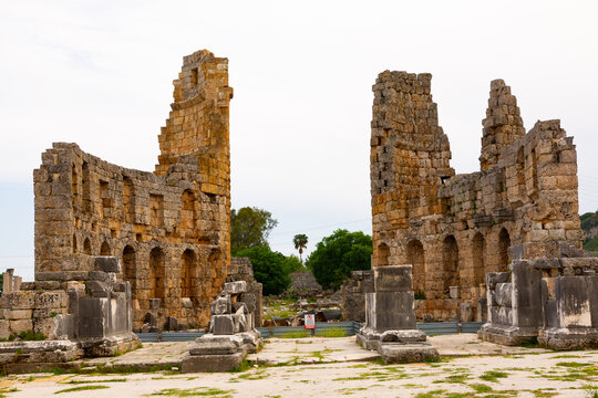 Ruins of Hellenistic gate of Pamphylian ancient city Perge located near modern Antalya, Turkey. View of courtyard and Hadrianus' Arch.