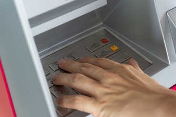 Man hand use ATM withdraw money hand close up