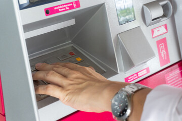Man hand use ATM withdraw money hand close up
