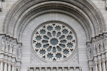 Obraz premium Beautiful sculpture at the entrance of Basilica of Sainte-Anne-de-Beaupre, Cathedral, Quebec an important Catholic sanctuary, which receives about a half-million pilgrims each year. 