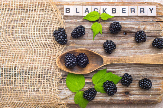 Ripe Blackberries On A Wooden Table In A Wooden Spoon. View From Above.