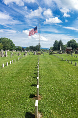 Fototapeta premium American flag is flown at half mast at the American War Cemetery in Charles Town, Virginia.