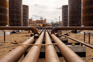 Oil refinery construction site with oil storage tanks in background.. High quality photo