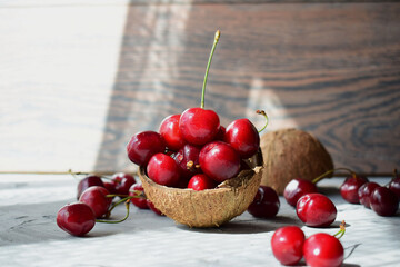 juicy delicious red cherry in coconut shell.