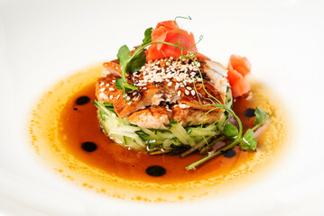 Fried eel with vegetables on the white plate