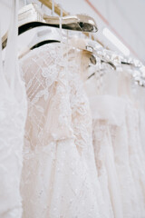 Rack of white wedding gowns