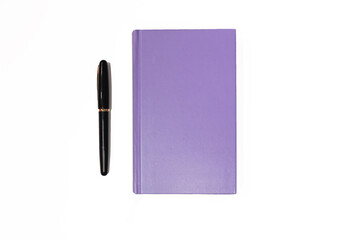 A purple notebook and a fountain pen on white background