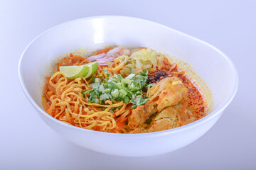 Thai spicy food, Egg noodle in chicken curry or name in thai is khao soi kai.noodles in soup cooked after the manner of the people of north Thailand on white background  with clipping path