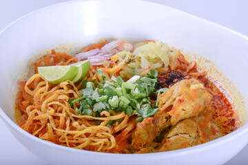 Thai spicy food, Egg noodle in chicken curry or name in thai is khao soi kai.noodles in soup cooked after the manner of the people of north Thailand on white background 