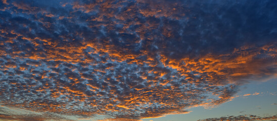 Scenic panoramic view of orange sunset and cloudscape