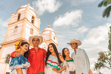 Traditional dancers with classical Latin American dance clothes in front of the cathedral in...