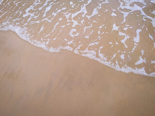Fototapeta na wymiar Beautiful clear waves on the sand