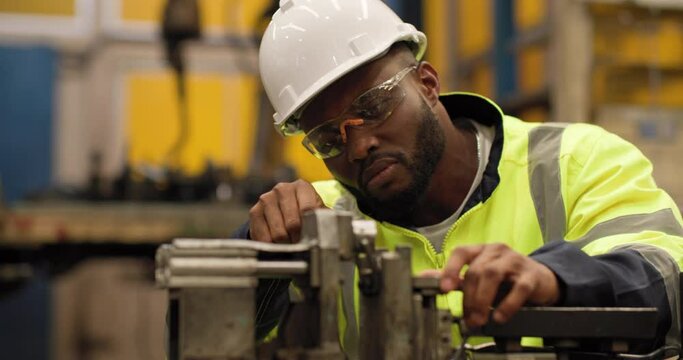 Professional industrial engineer African american man develop artificial intelligence in manufacturing industry. Automation robot arms machine in background. Smart Innovation Technology concept.