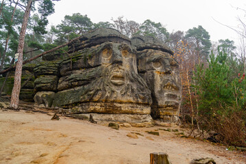 Heads carved into rock. Monument , history, nature, park.