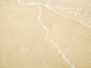 Bubble sea wave on blown sand beach sea and water reflect in blown sand background this image in background and texture concept