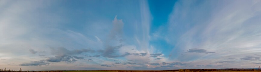 Obraz premium Panorama of sunny and stormy sky on a background of mountains