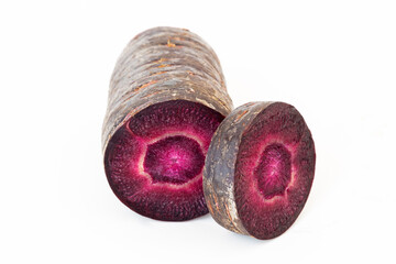 Cutted and sliced root vegetables of black carrot or Scorzonera isolated on a white background. An unusual and healthy ingredient for nutrition and dieting
