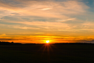Beautiful lanscape sunset nature rural background.Field of grass during sunset dark evening.