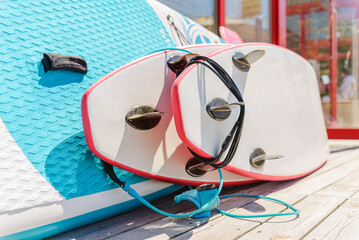 Surfboard rentals waiting for tourists on the summer hot beach.Closeup.