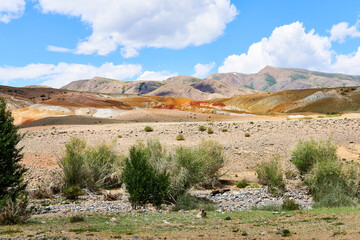 The mountains are deserted on a sunny day with blue skies and white clouds. Mountains of Altai. Beautiful photo wallpaper. Mars - 1.