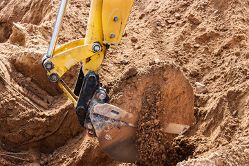 Excavator digs piles. Earthworks for the construction of the foundation. Construction equipment for...