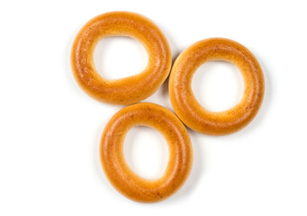 Three dried bagels on a white background.