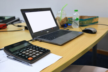 Calculator and laptop for officer working in office, Laptop and stationary for daily work of officer