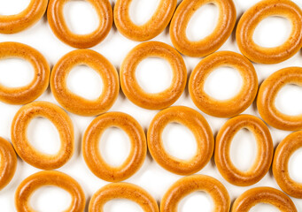 Pattern of dried bagels in white background.
