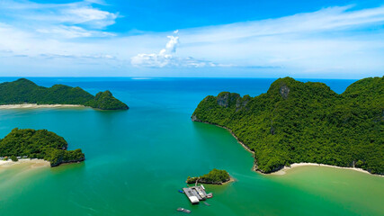 Aerial view of  summer tropical islands in the ocean as white sand beach with tourists and turquoise water background