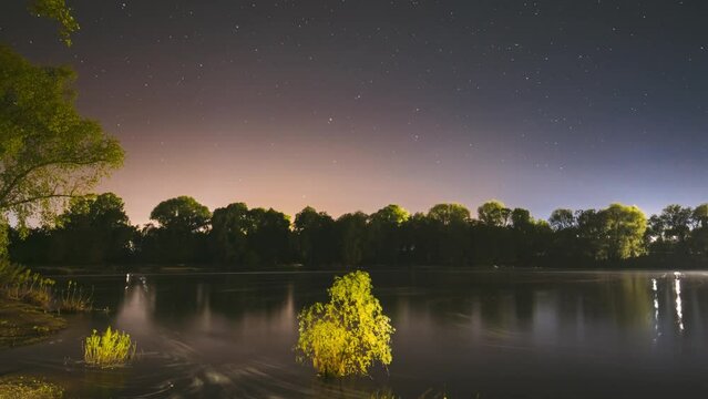 Night Sky Above River. 4k Hyperlapse. From Dusk To Dawn. Stars Float Across Sky. Night Sky Turns Into Morning. Meteors Fly Across The Night Sky. Dawn Is Coming. Meditation By The Water. Calmness And