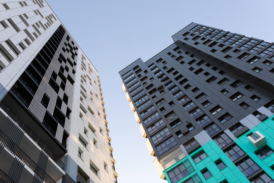 two tall multi-colored apartment buildings, bottom view
