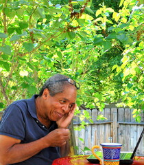 Naklejka na ściany i meble Male senior working on his laptop computer outdoors.
