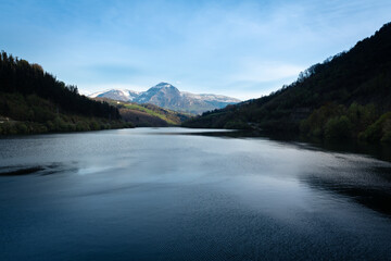 Fototapeta na wymiar Ibiur reservoir with Txindoki mountain as background, Basque Country in Spain